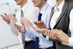 Photo of business partners hands applauding at meeting